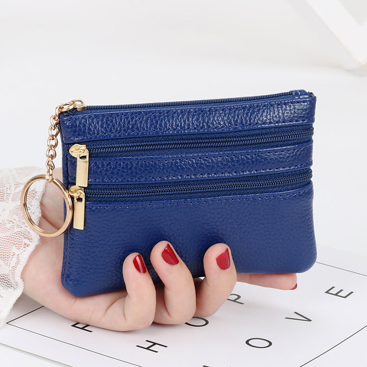Women's Coin Purse Short and I in black leather with multiple zippered compartments and a keyring attached.