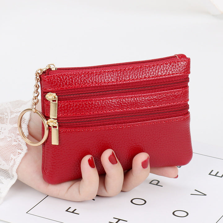 Women's Coin Purse Short and I in purple with multiple zippered pockets, held in hand.