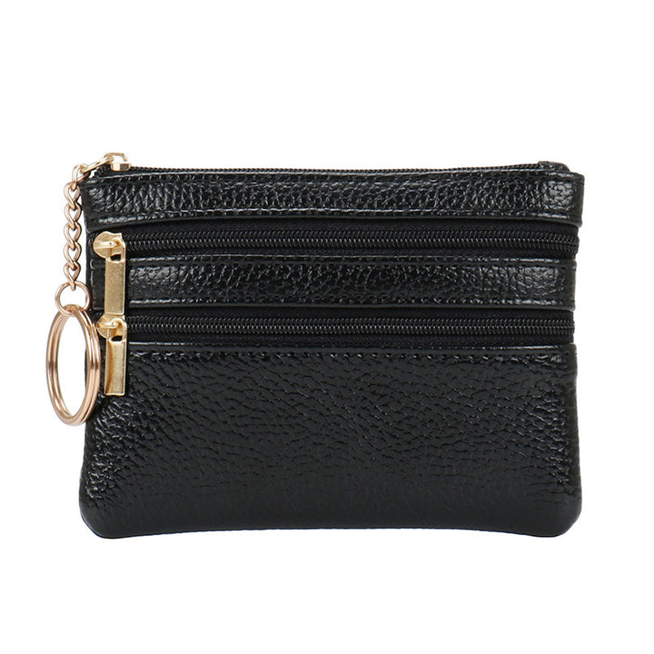 Women's Coin Purse Short and I in black leather with multiple zippered compartments and a keyring attached.