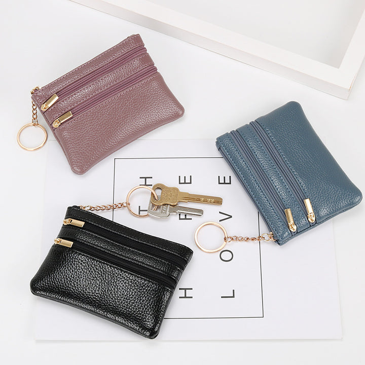 Women's Coin Purse Short and I in black leather with multiple zippered compartments and a keyring attached.