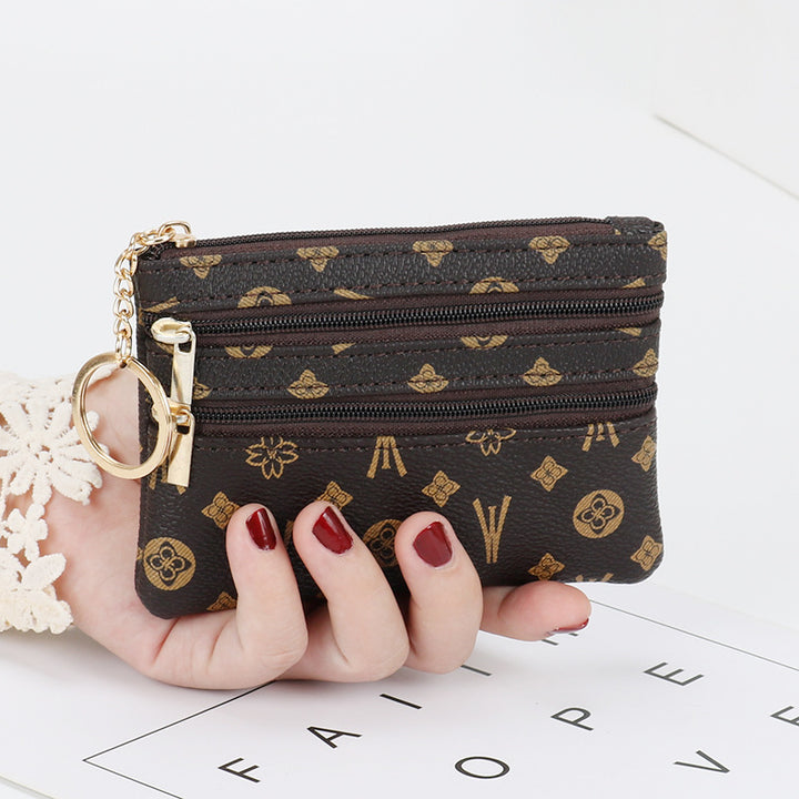 Women's Coin Purse Short and I in purple with multiple zippered pockets, held in hand.