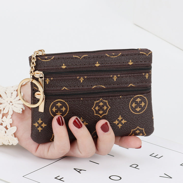 Women's Coin Purse Short and I in purple with multiple zippered pockets, held in hand.